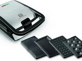 a close up of a waffle maker and four waffles