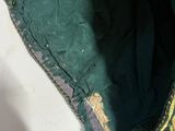 a green purse with a gold design on the inside of it