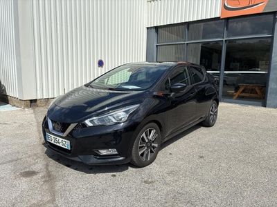 a black car parked in front of a building