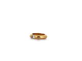 a close up of a gold ring with a diamond on it