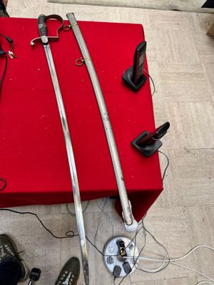 two swords and a pair of shoes on the floor