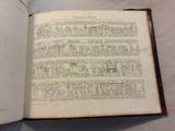 an open book with drawings on it on a table