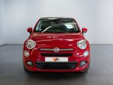 the small red car is parked in the large white room