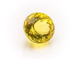 a yellow sapphire stone on a white background