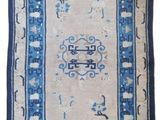 a blue and white rug on a white background