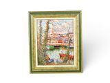 painting of a river scene with boats and trees in a gold frame