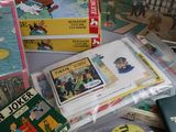 a pile of children ' s books and dvds on a table