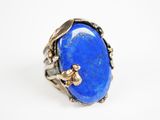 a close up of a ring with a blue stone in it