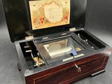 a wooden box with a glass top that has a music box inside of it
