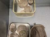 two tins with coins in them sitting on a counter
