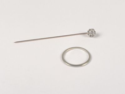 a silver ring and a silver ring on a white surface