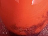 a large orange vase sitting on a table
