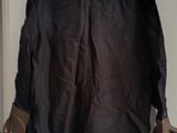 a black jacket hanging on a wall in a room