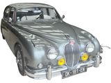 a silver car that is sitting on a white surface