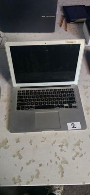 a laptop computer sitting on a table in a living room