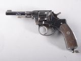 a close up of a revolver on a white surface
