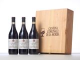 three bottles of wine in front of a wooden box