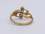 a close up of a gold ring on a white surface