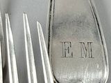 a fork, spoon and spoon with a name on it