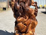 a wooden sculpture of horses on a wooden pallet