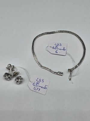 a silver bracelet and a silver bracelet with a tag on it