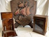 a wooden plaque with a ship on it next to a wooden box