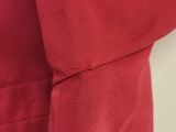 a close up of a red dress with buttons on the back