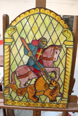 painting of a man riding a horse in a stained glass window