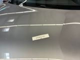 a sticker on the hood of a silver car