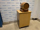 a wooden barrel sitting on top of a wooden stand