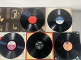 four vinyl records sitting on top of each other on a table
