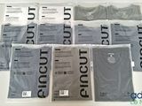 un grand nombre de t-shirts posés sur une table