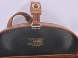 a close up of a brown leather bag with a handle