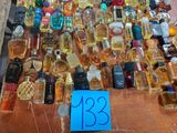 many bottles of perfume on a table with a price tag
