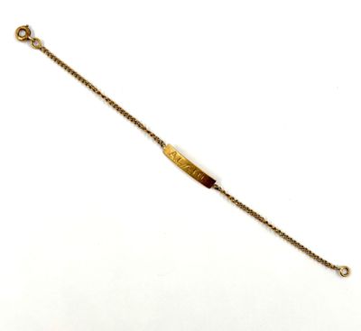 a close up of a gold bracelet with a chain on a white background