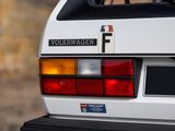 a close up of a white car with a number plate on it