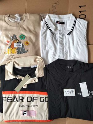 several t - shirts are laid out on a cardboard box on a table
