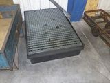 a metal grate on the floor next to a wooden cart