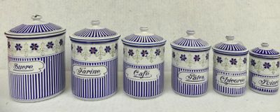 five blue and white canisters with purple flowers on them