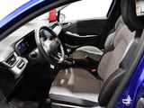 the interior of a blue car with a steering wheel and dashboard