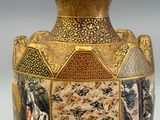 a vase with a picture of people on it