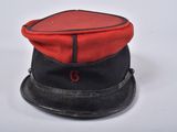 an image of a red and black hat sitting on top of a white table