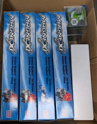 four boxes of toothpaste sitting in a cardboard box on top of a table