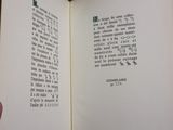 a hand holding a book open to a page of text
