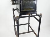 an old typewriter sitting on a stand on a white background