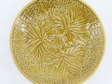 a yellow plate with a flower design on it