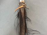 a small doll with a long hair and a hat on it ' s head