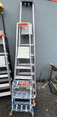 two ladders that are next to each other on the ground
