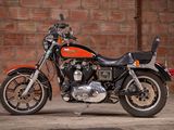 a motorcycle that is parked in front of a brick wall