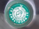 a close up of a bottle of water with a green label